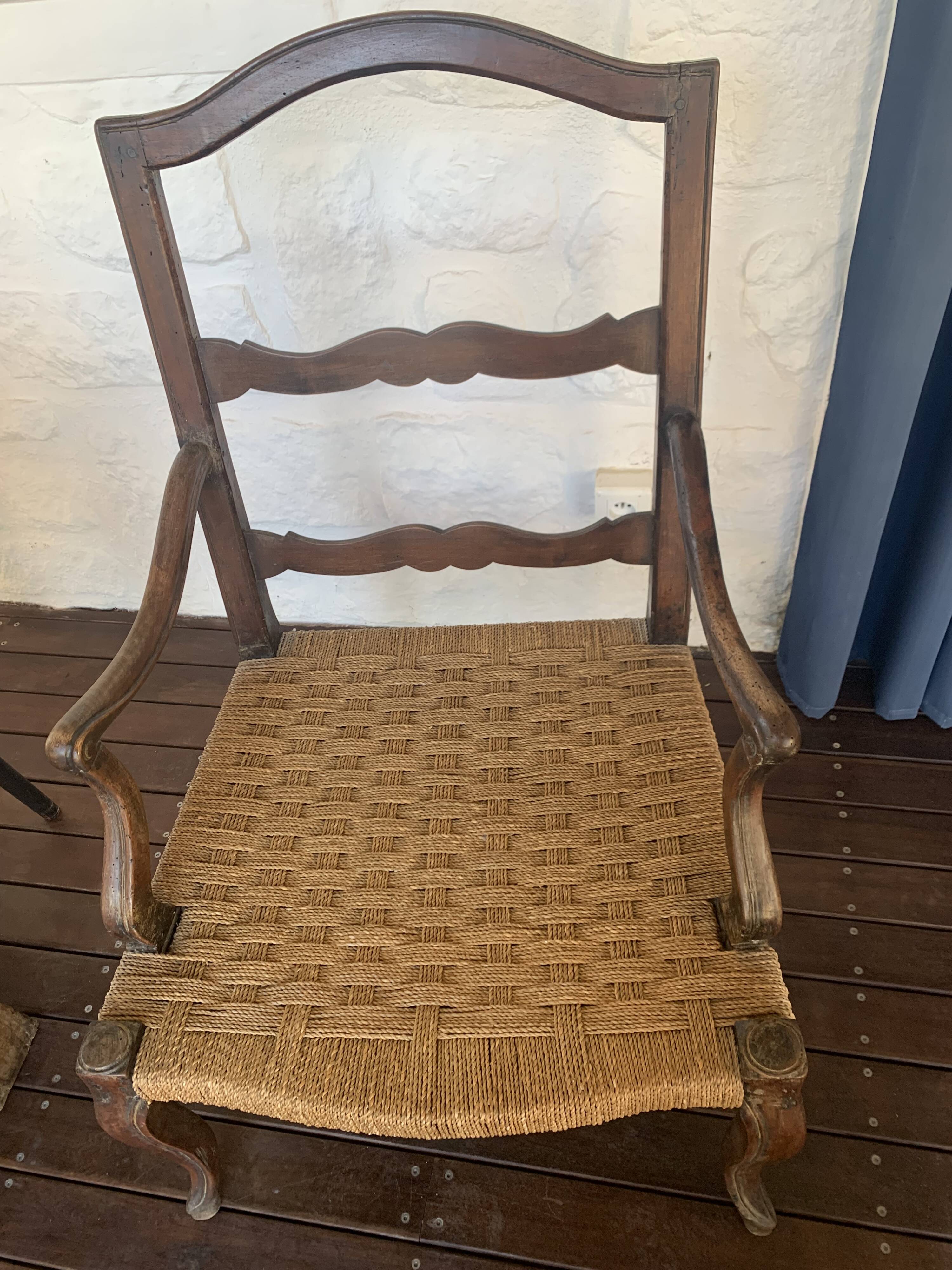 Pair of antique wooden armchairs with woven seats + cushions