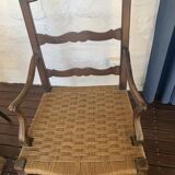 Pair of antique wooden armchairs with woven seats + cushions