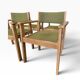 Vintage wooden chair with olive green seat and armrests.