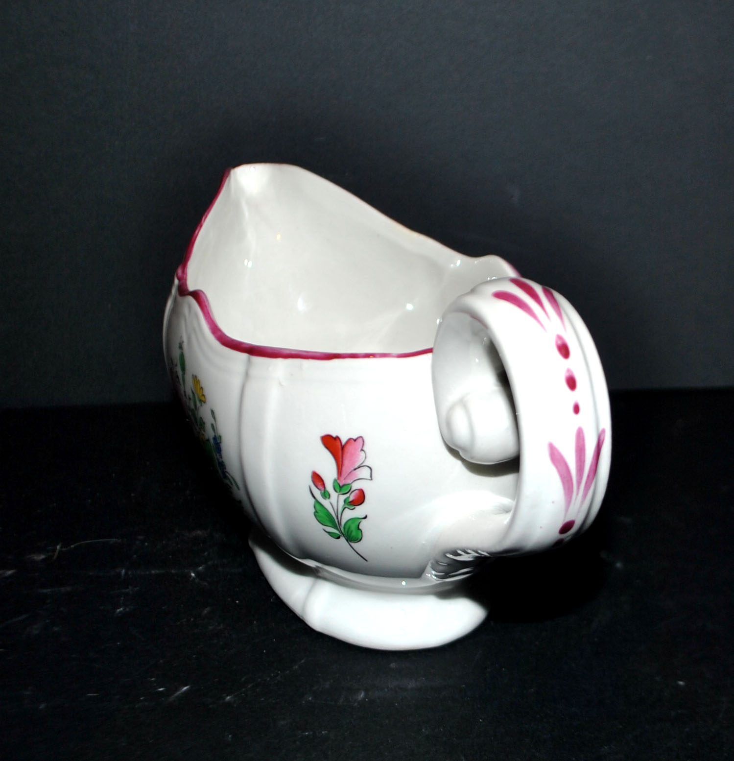Lunéville KG earthenware sauce boat with polychrome painted flowers, revolving lamp.