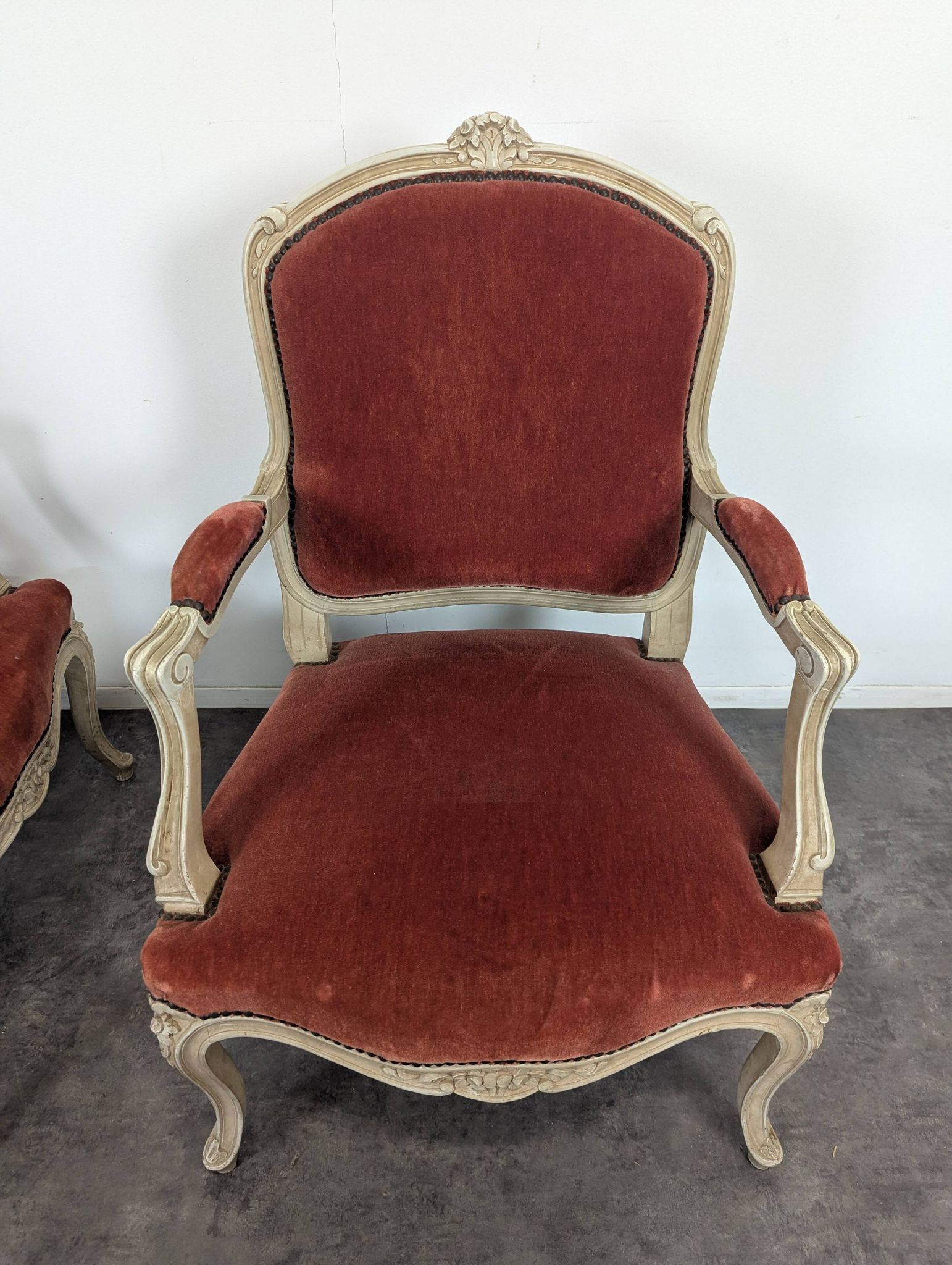 Pair of red cabriolet armchairs in Louis XV style