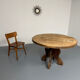 Round table in solid wood, thick top, vintage brutalist style from the 1960s.