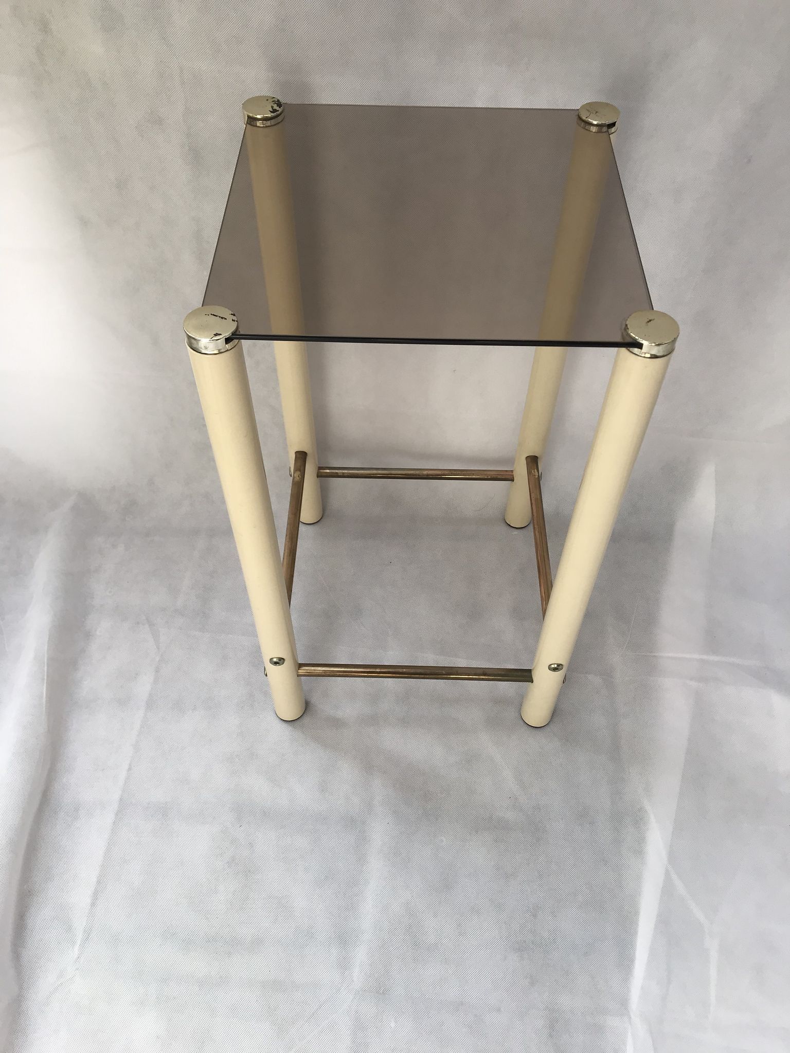 Square side table in metal and smoked glass.