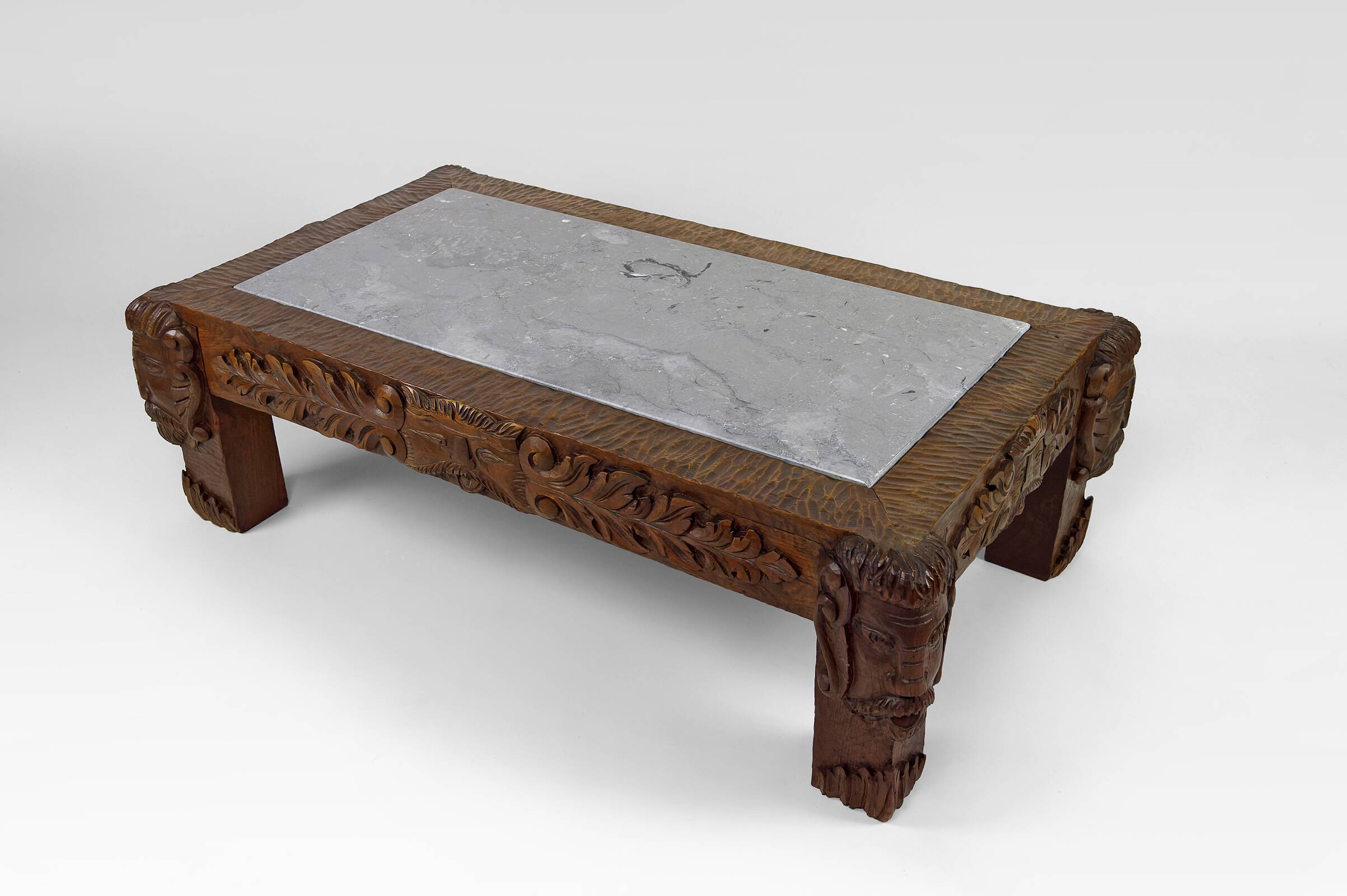 Solid oak coffee table carved with fauns and gray marble top, France, circa 1940