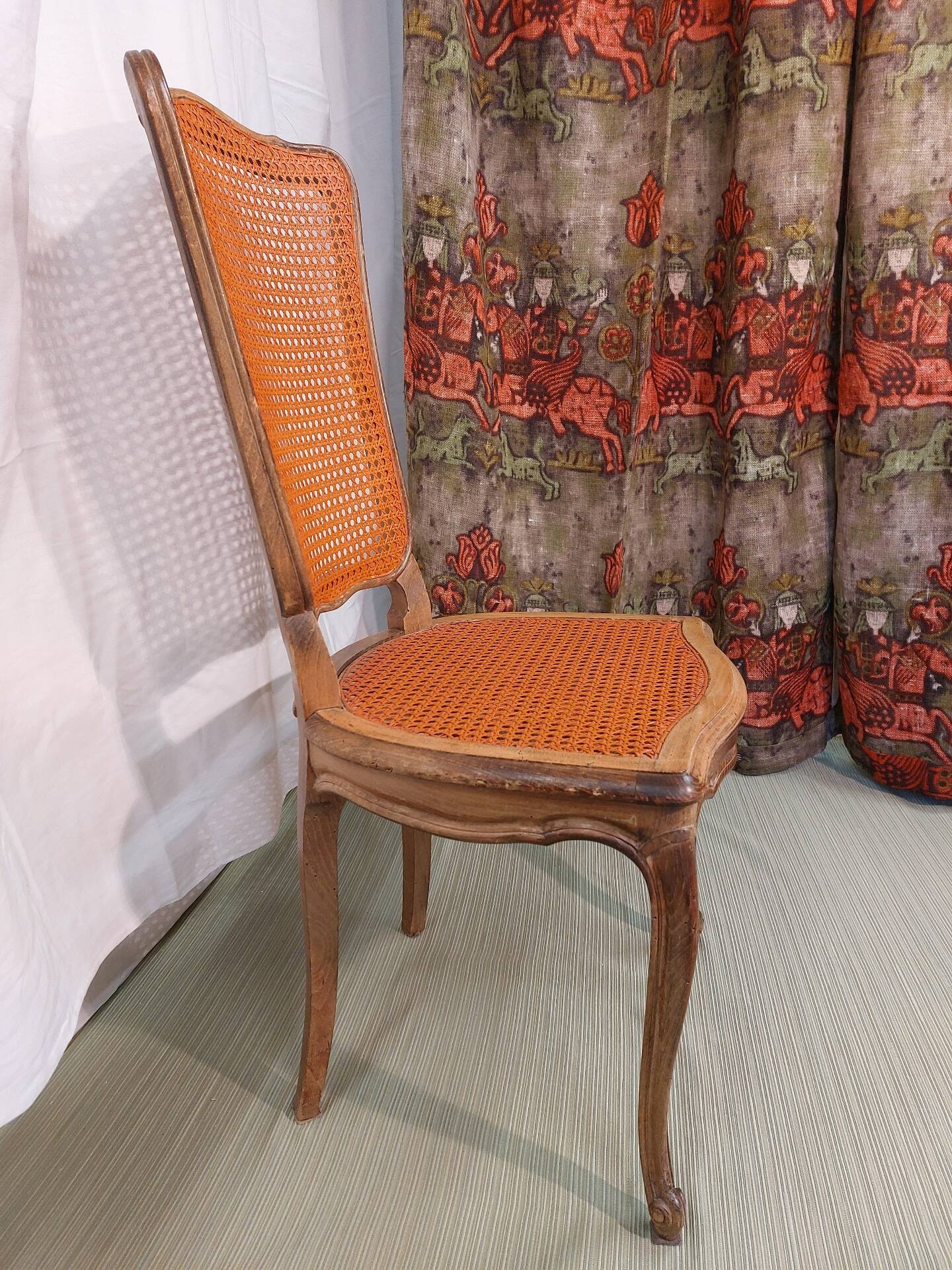 Caned chair in Louis XV style painted orange.