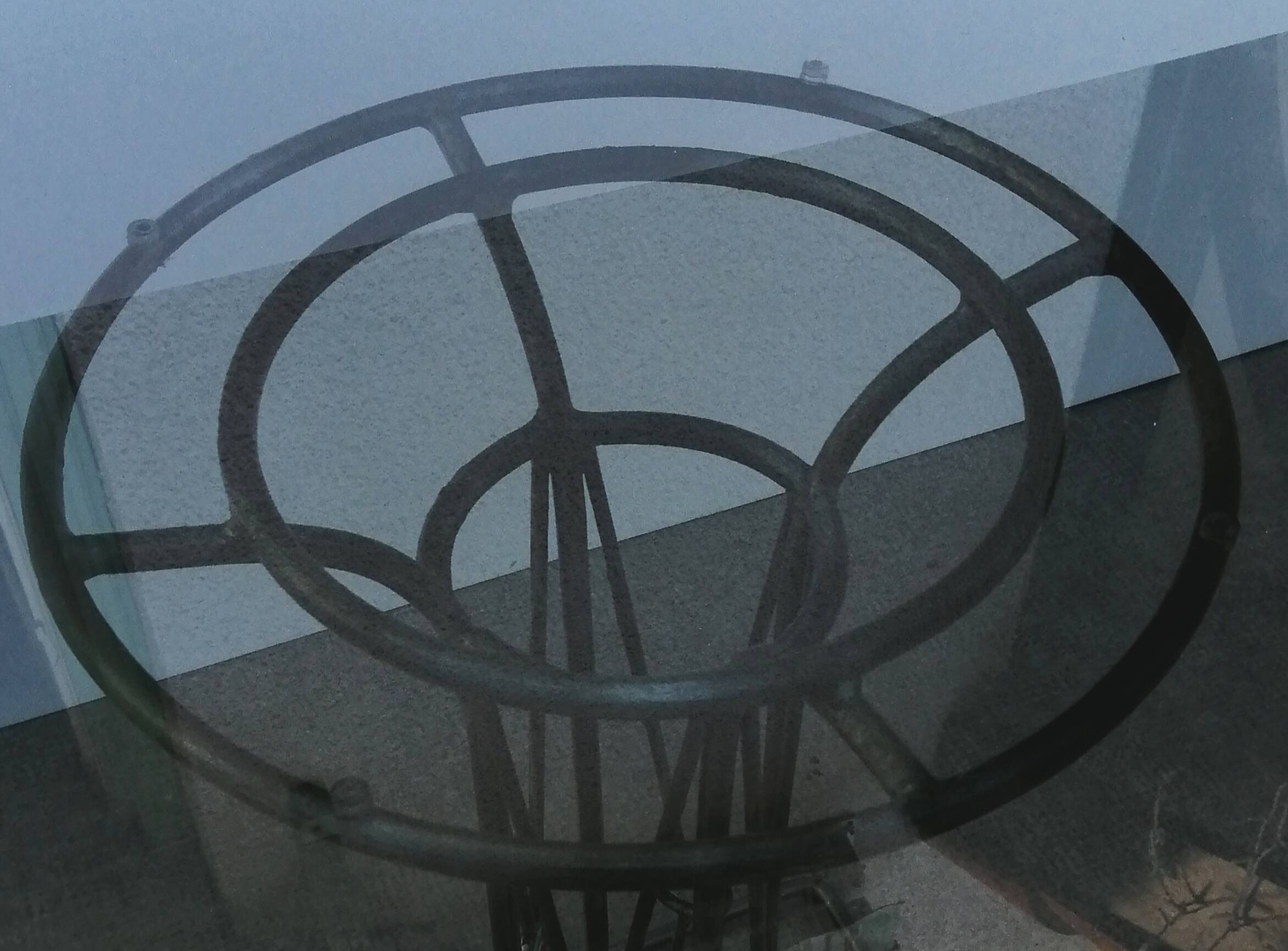 Wrought iron dining table with its round smoked glass top, vintage 1980