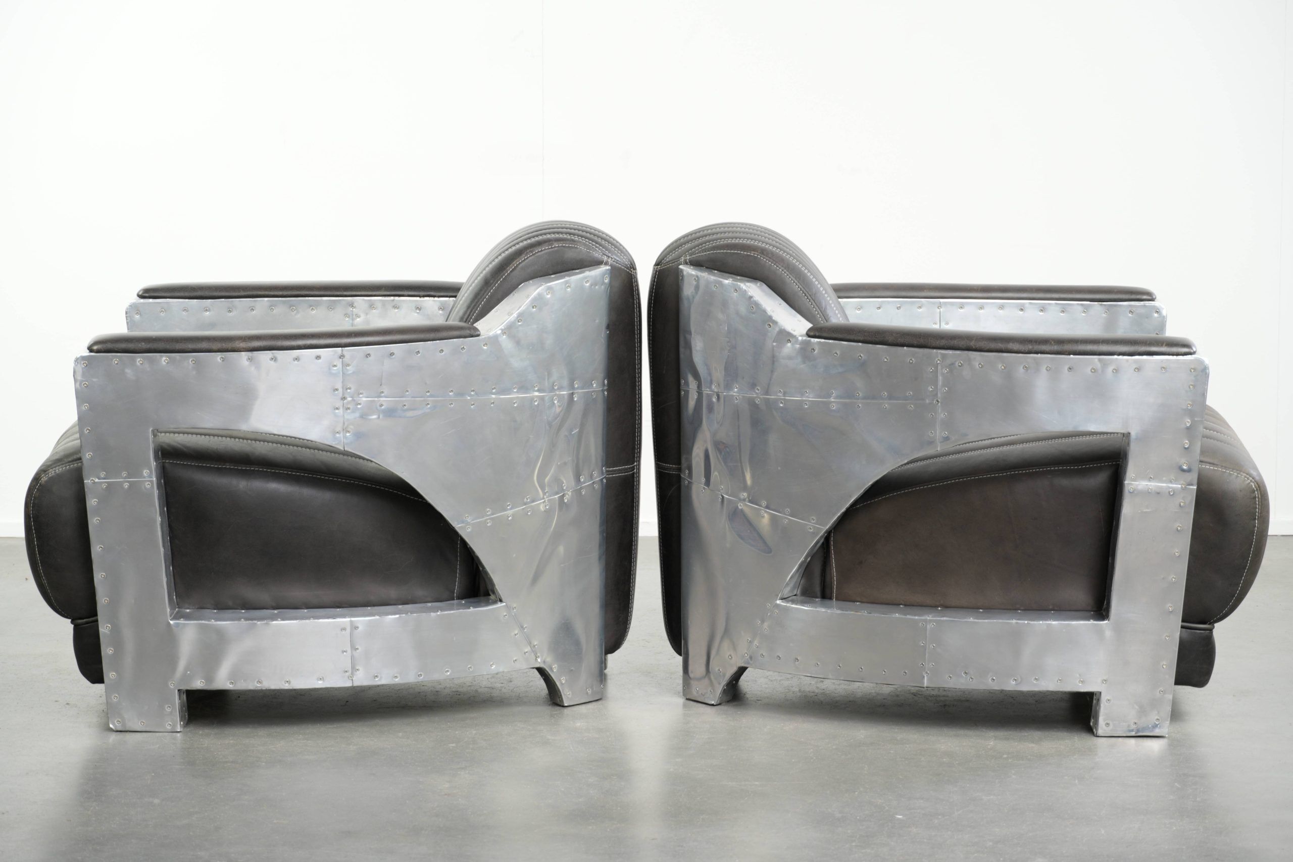 Set of 2 sturdy industrial black cowhide Aviator design armchairs with aluminium and rivets