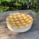 Set of nine flat ceramic plates yellow Scottish decoration in yellow/orange gridded ceramic