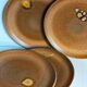 Four vintage glazed stoneware potter's plates