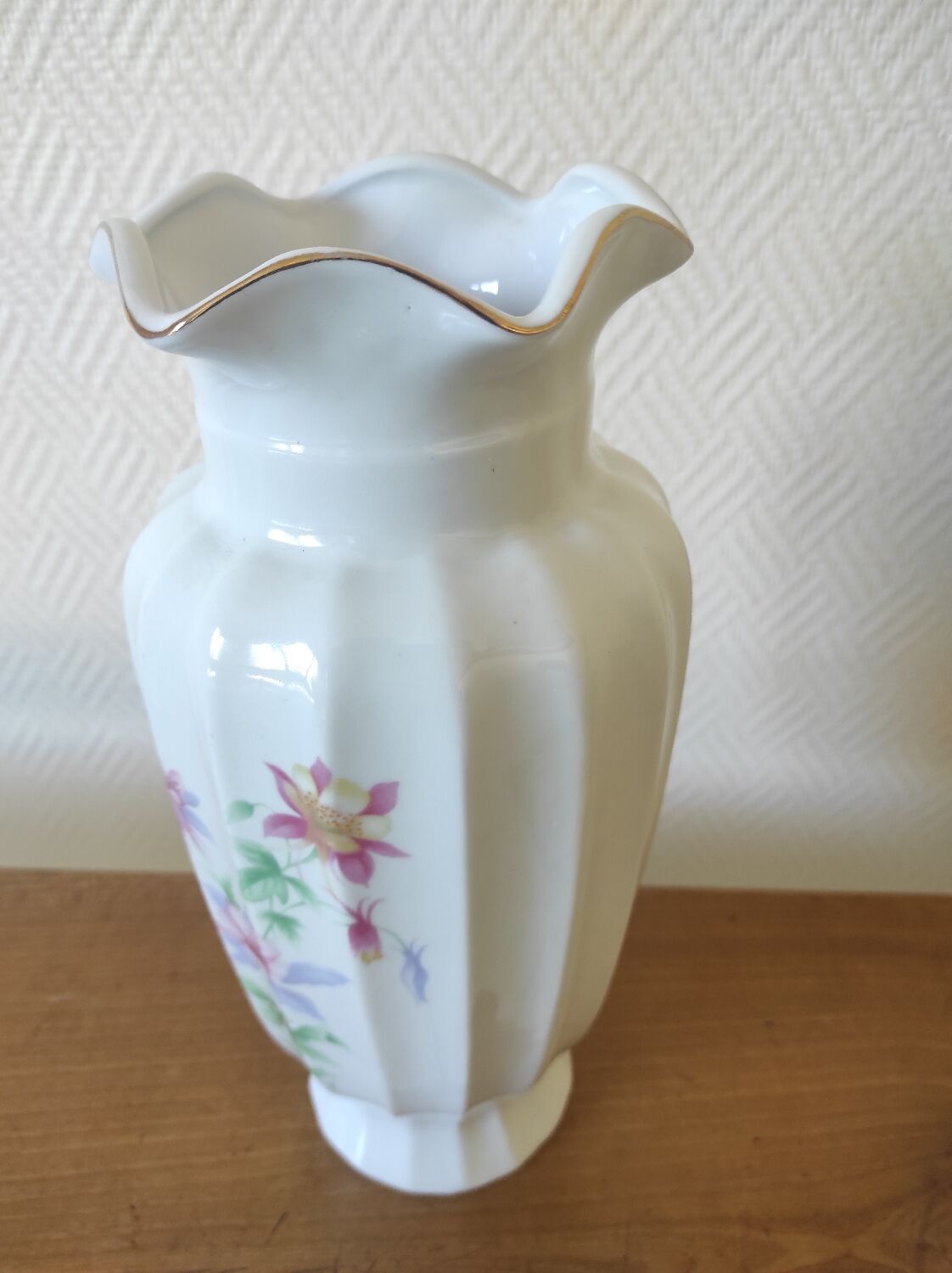 Porcelain vase with floral decoration and gold trim.