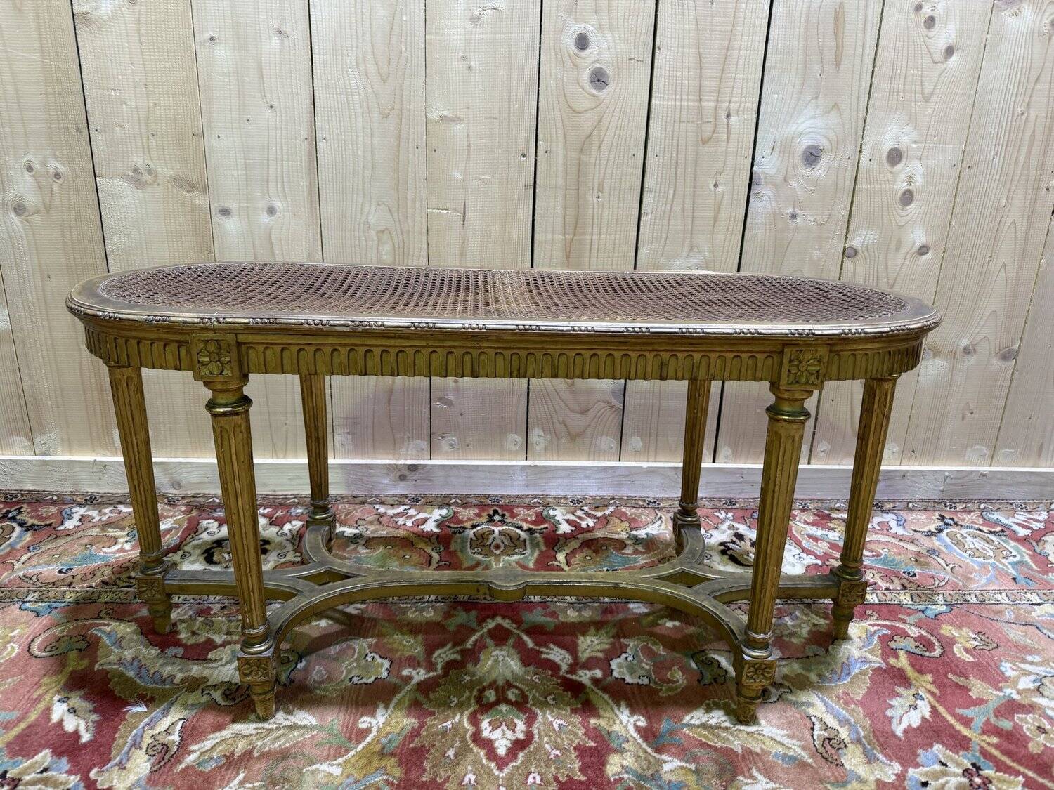 Bench - Piano bench in caning and gilded wood in the Louis XVI style.