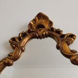 Old wooden mirror and gilded stucco