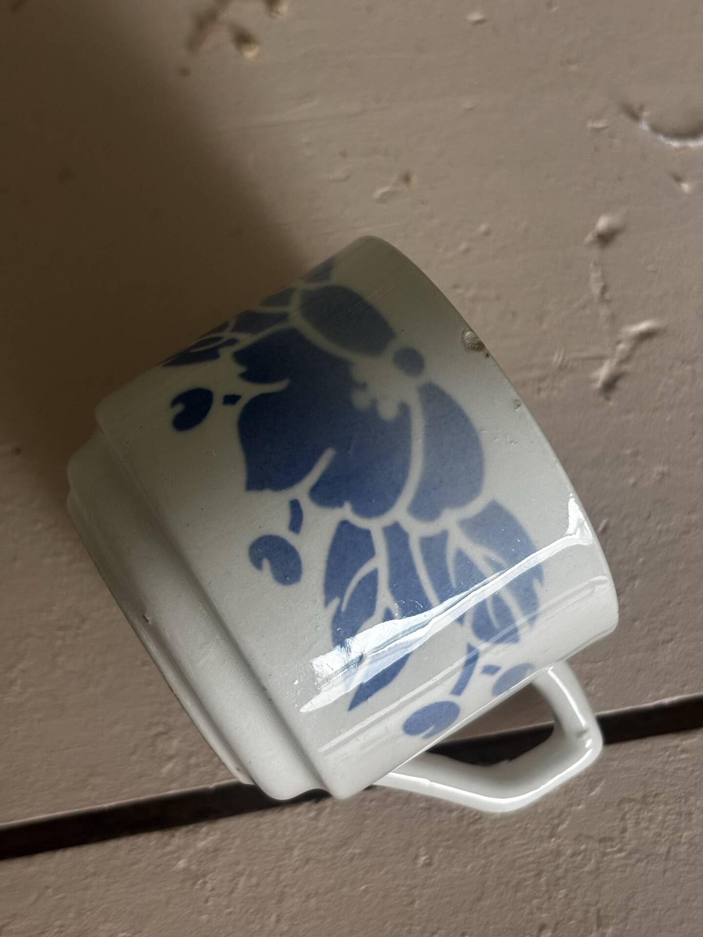 Set of 3 antique ceramic cups with blue floral pattern.