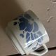 Set of 3 antique ceramic cups with blue floral pattern.