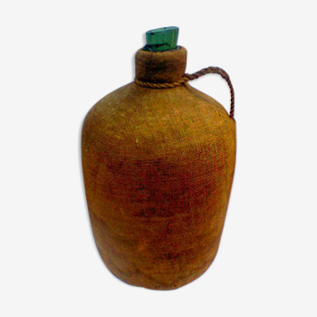 Demijohn dressed in burlap and padded cork