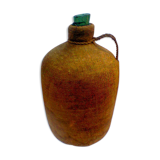 Demijohn dressed in burlap and padded cork