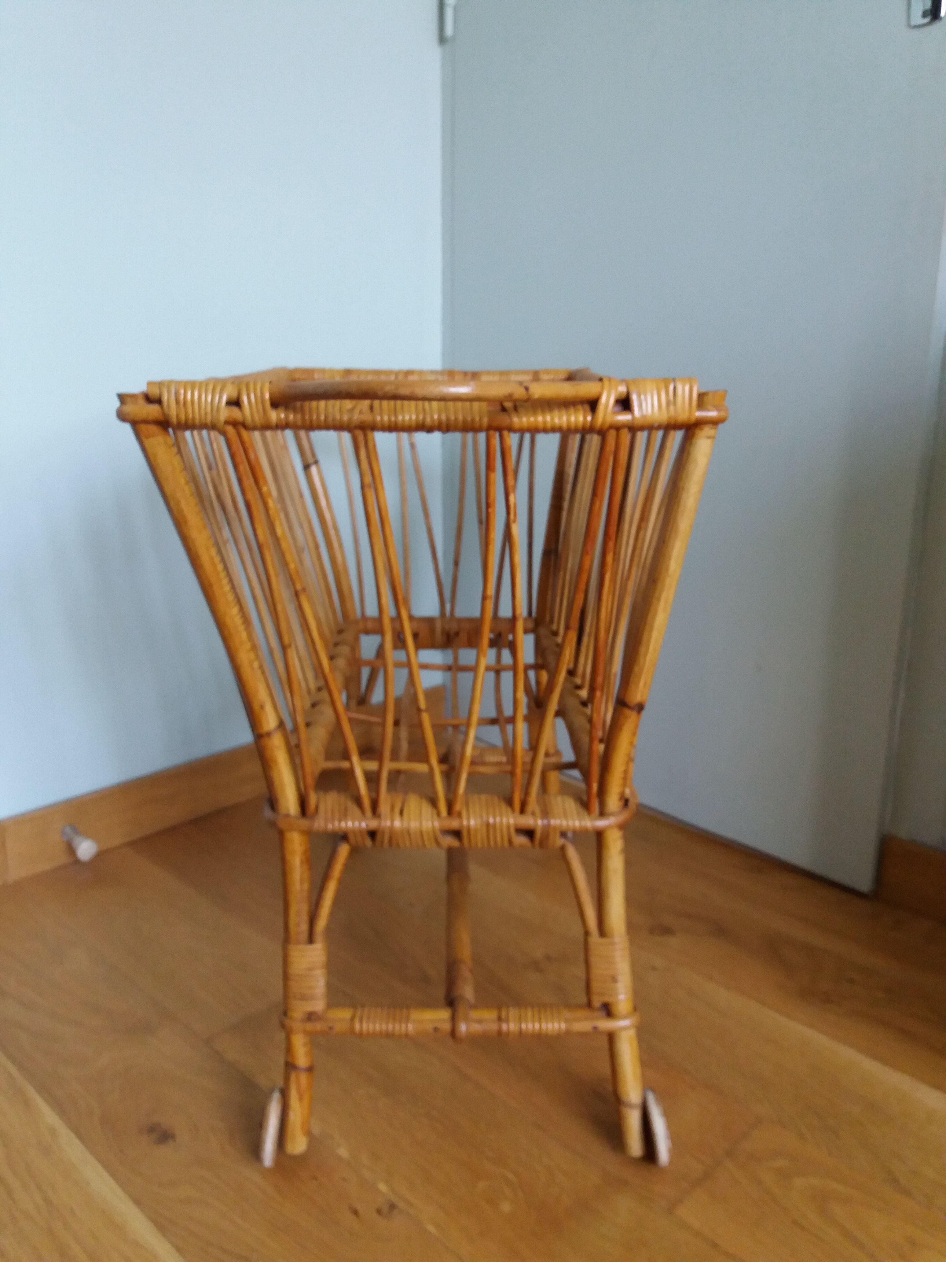 Rattan wicker cradle on wooden wheels