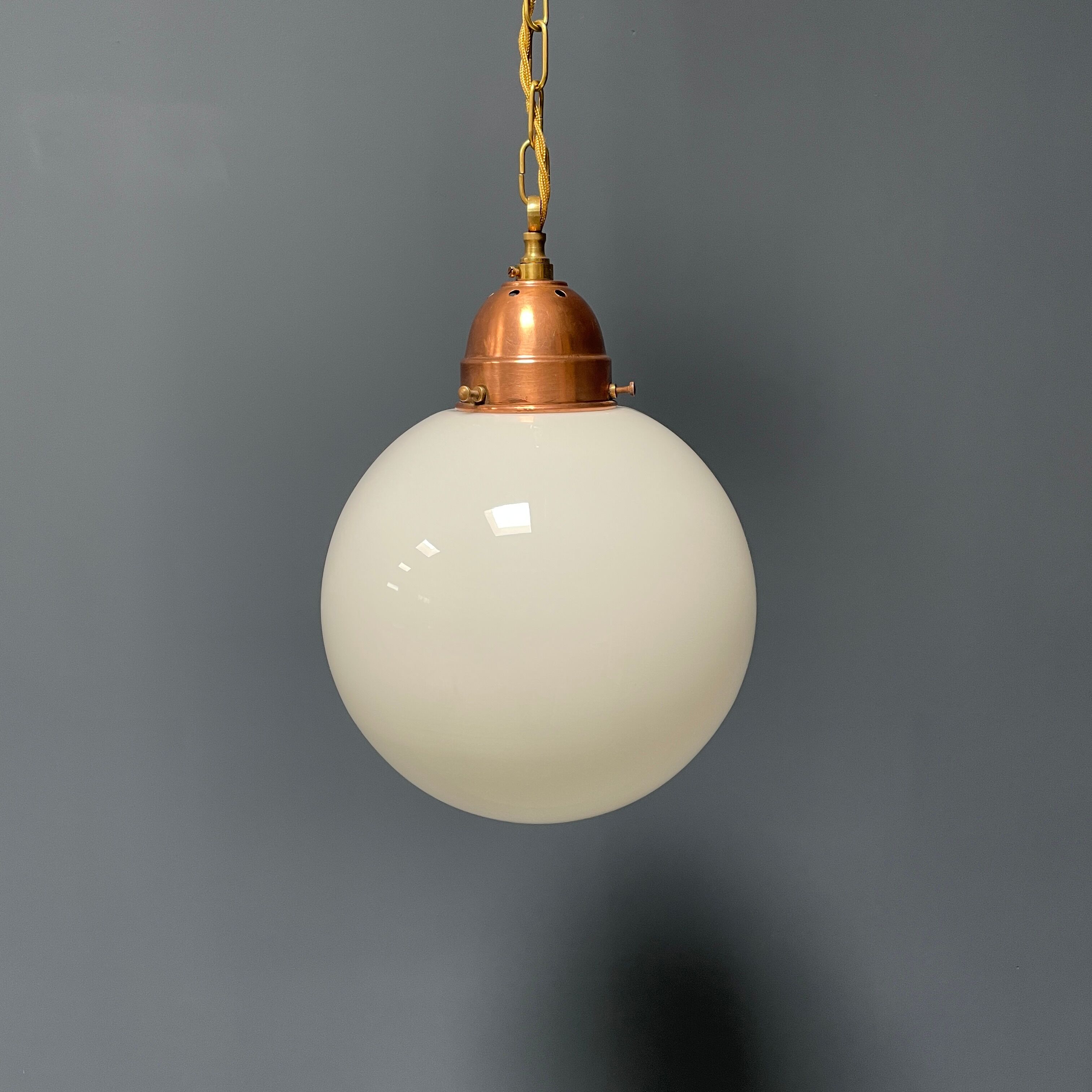 Opaline glass ball hanging lamp with copper fixture