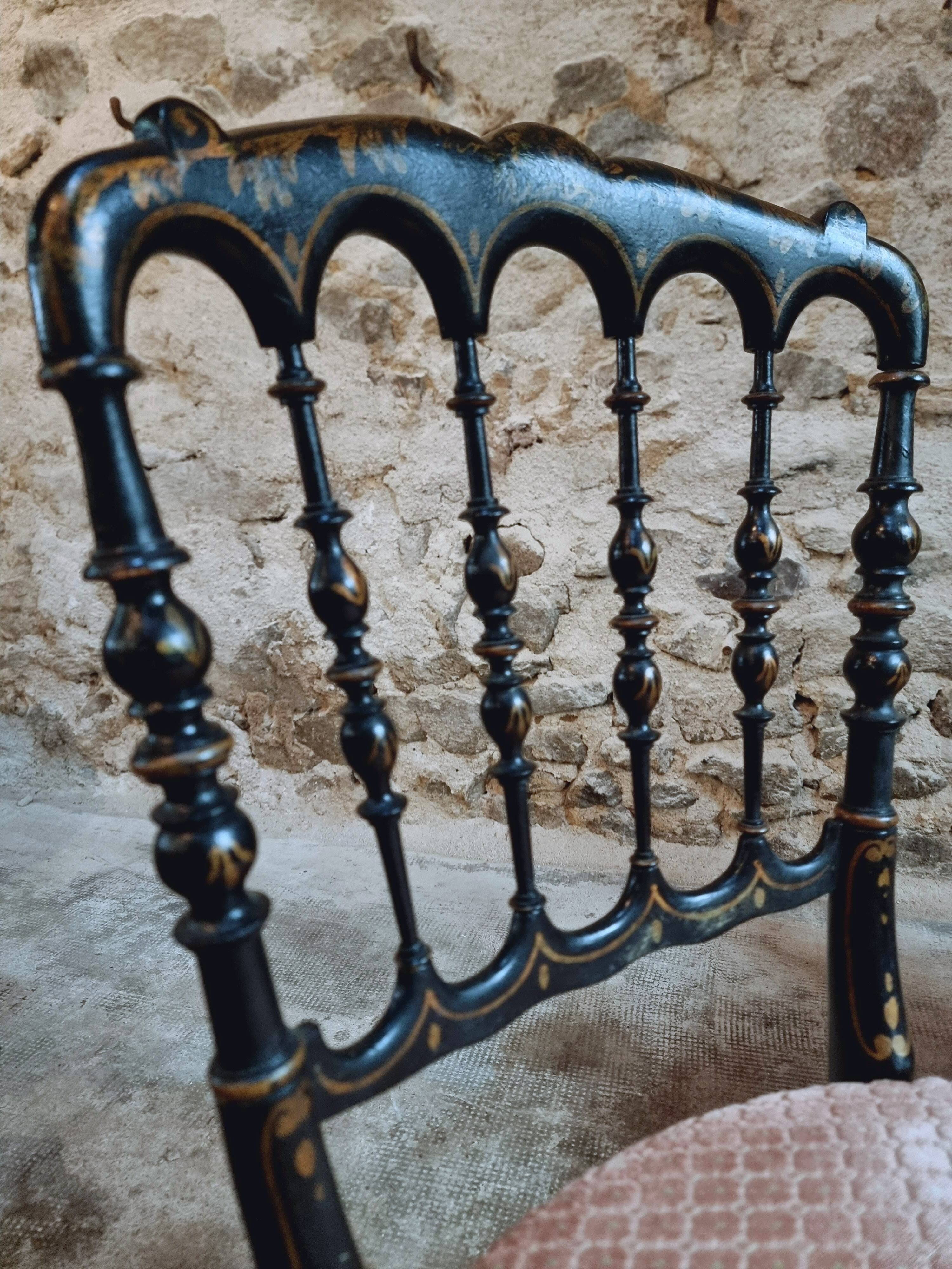 Pair of antique Napoleon III chairs in blackened wood and fabric.