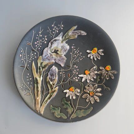 Black ceramic plate with wildflower design, Ruscha Art Pottery, Germany.