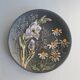 Black ceramic plate with wildflower design, Ruscha Art Pottery, Germany.