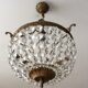 Old chandelier with bronze stamps