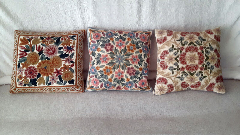 Set of three old hand-embroidered wool cushions