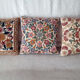 Set of three old hand-embroidered wool cushions