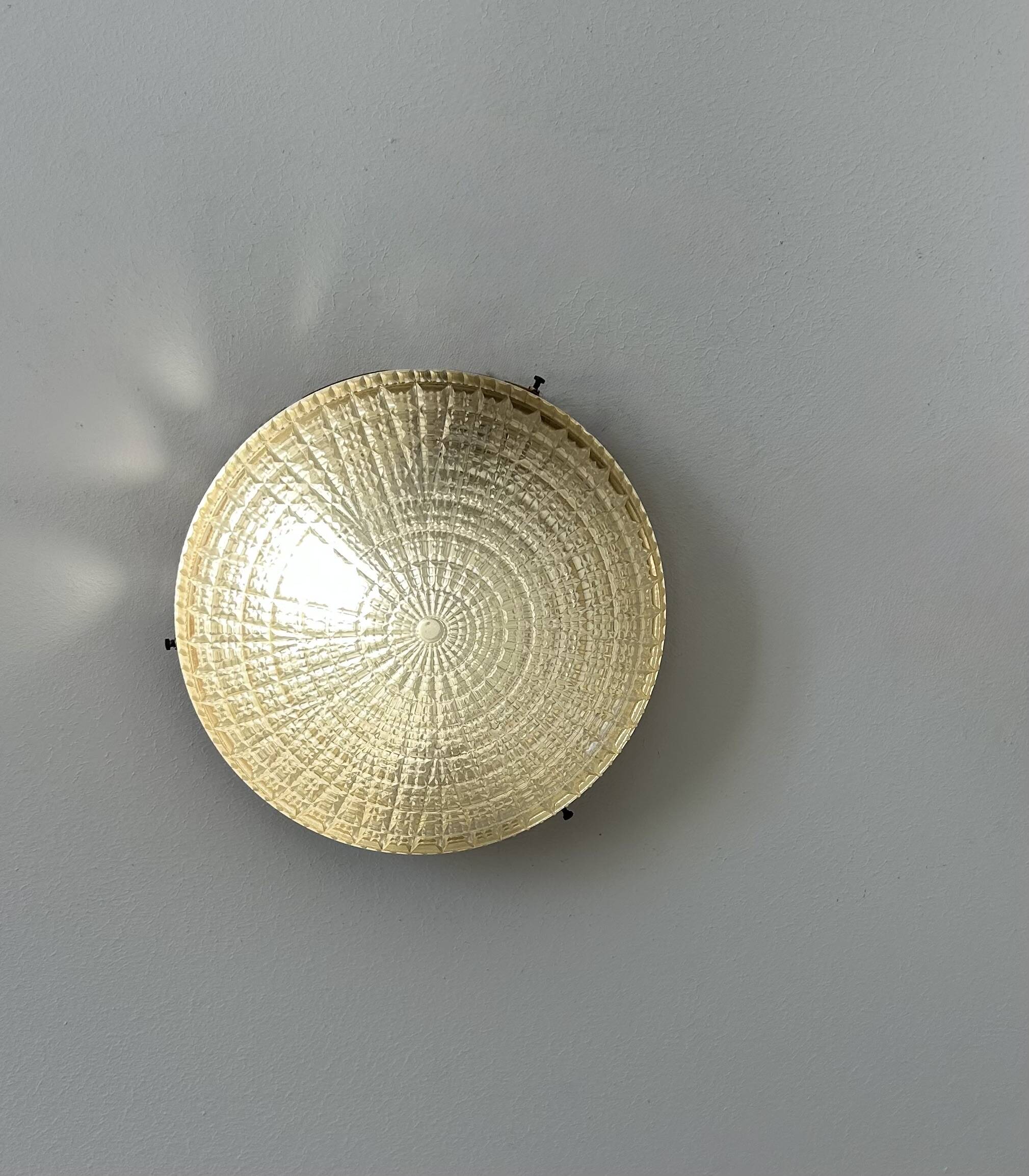Pair of vintage wall lights in gilded metal and pressed moulded glass, France, 1970.