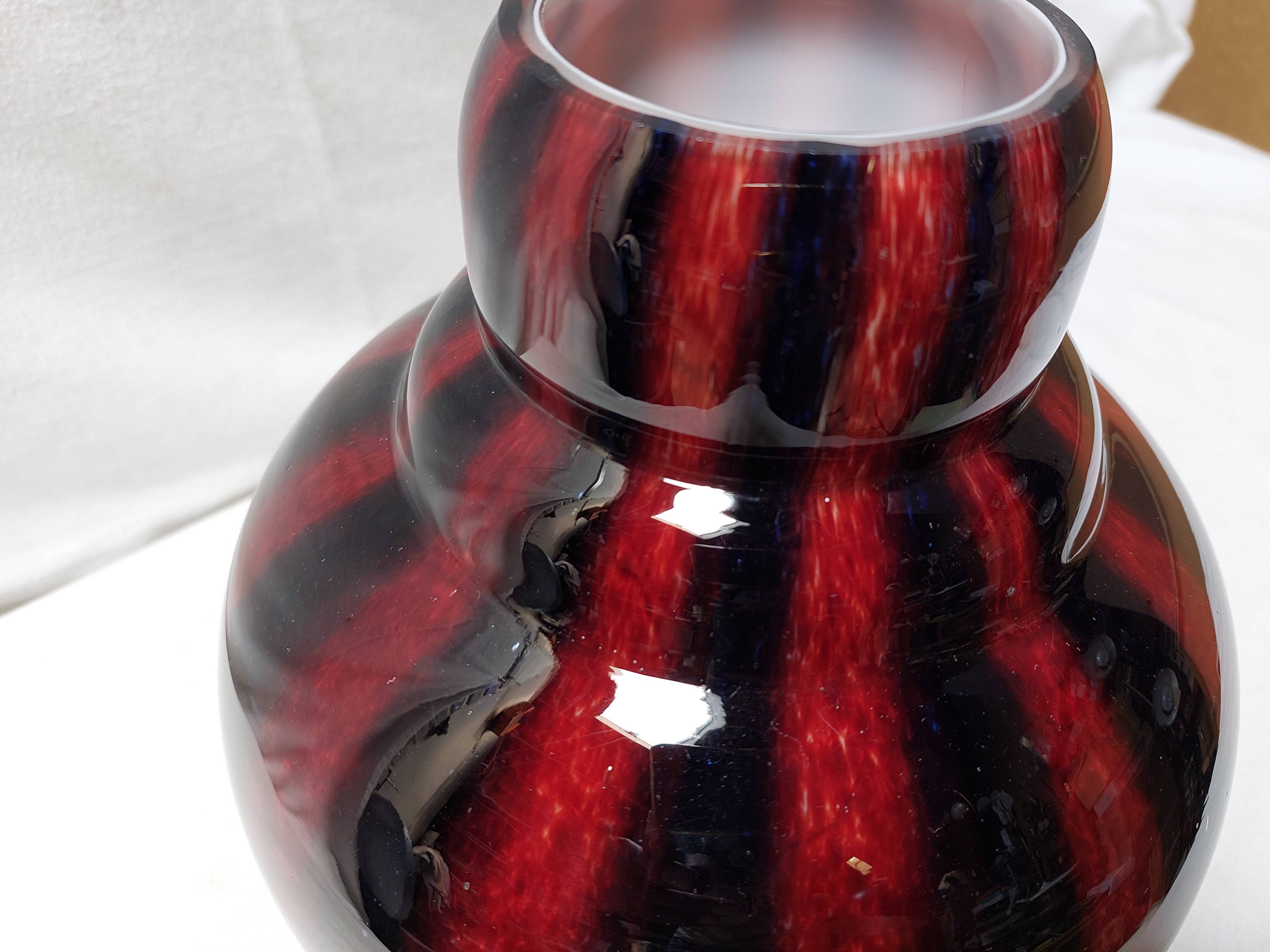 Large vintage blown glass ball vase with red and midnight blue flamed decor