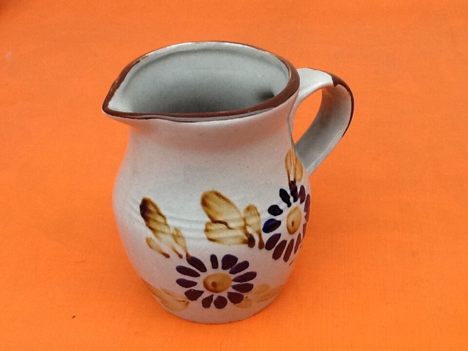 Glazed ceramic pitcher floral decoration
