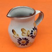 Glazed ceramic pitcher floral decoration