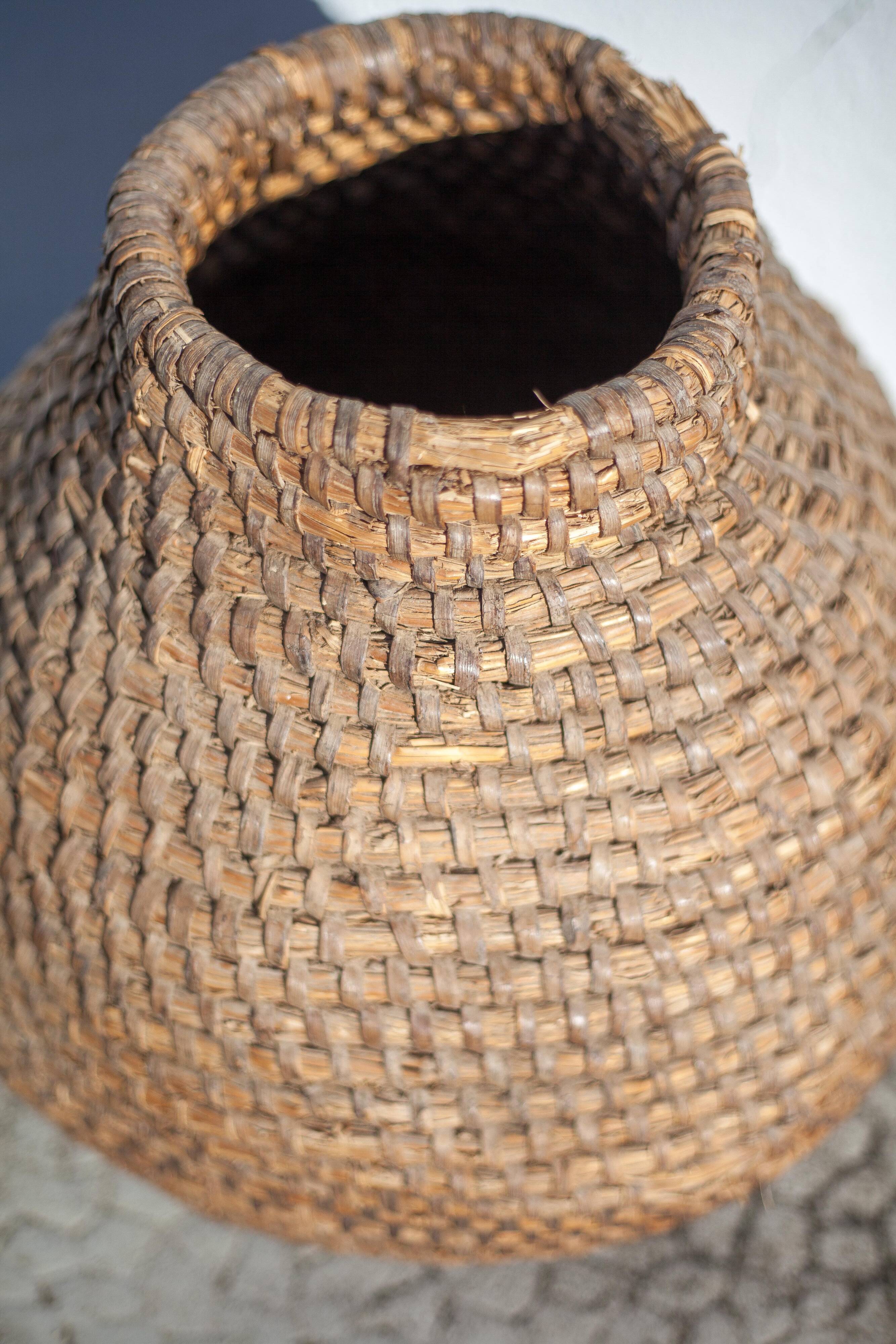 Old basket, burgundy straw and bramble, woven basket, interior decoration