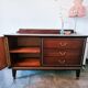 Dark wood sideboard with brass finishes and compass feet