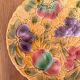 Round earthenware dish decorated with fruit in Sarreguemines slipware