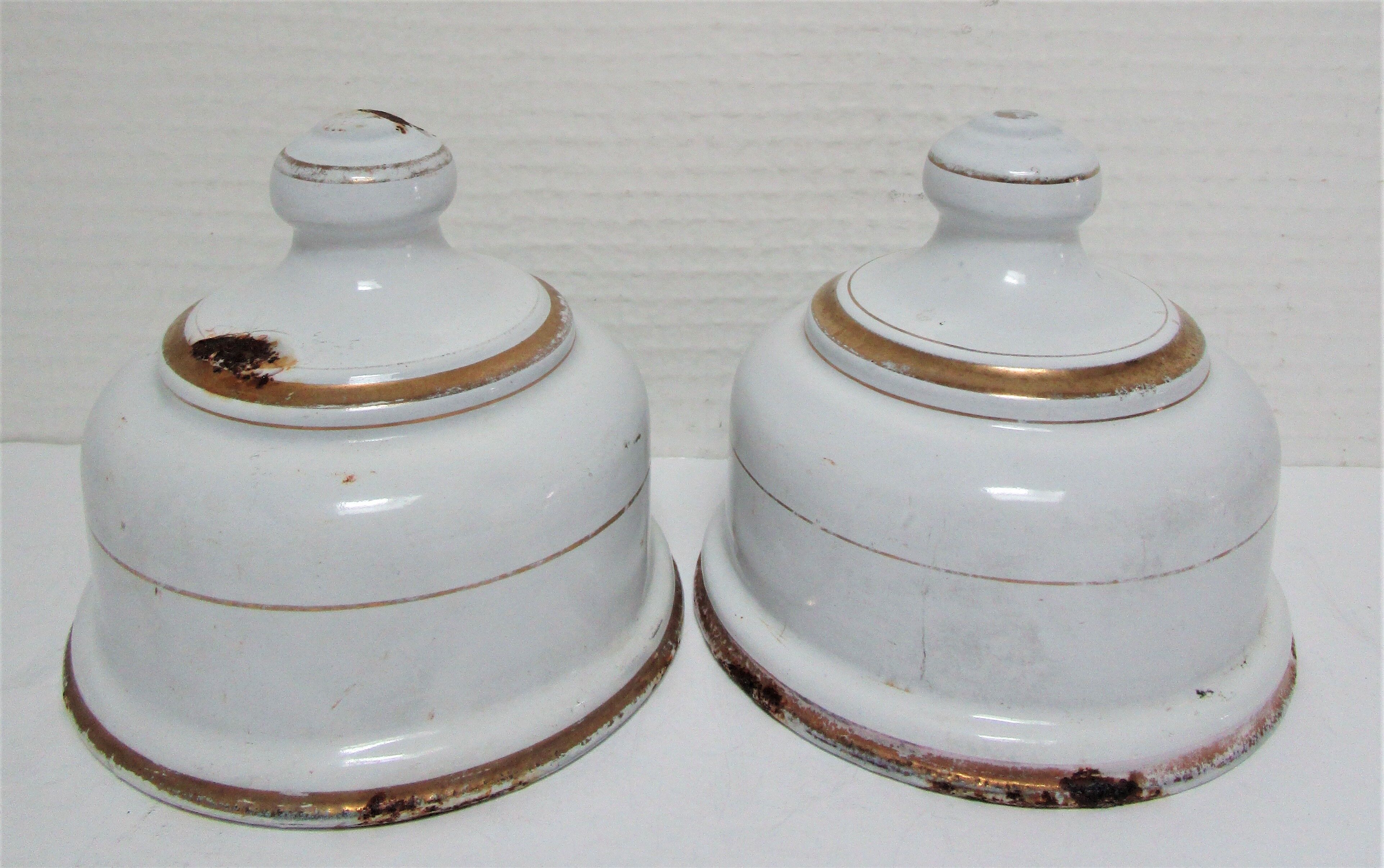 Four white enamelled metal cheese bells early twentieth century