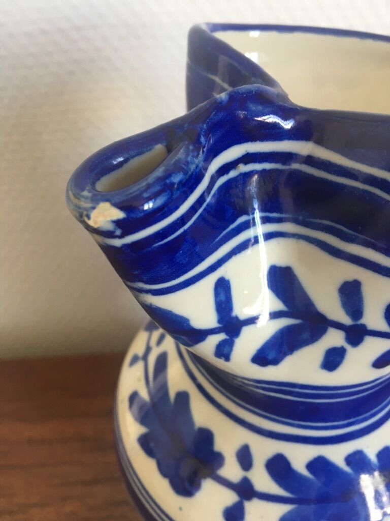 Enamelled ceramic pitcher, blue and white floral decoration, signed