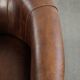 Sheepskin clubarmchair with beautiful patina finished with decorative nails