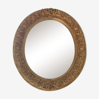 Oval mirror 19 eme in wood and gilded stucco