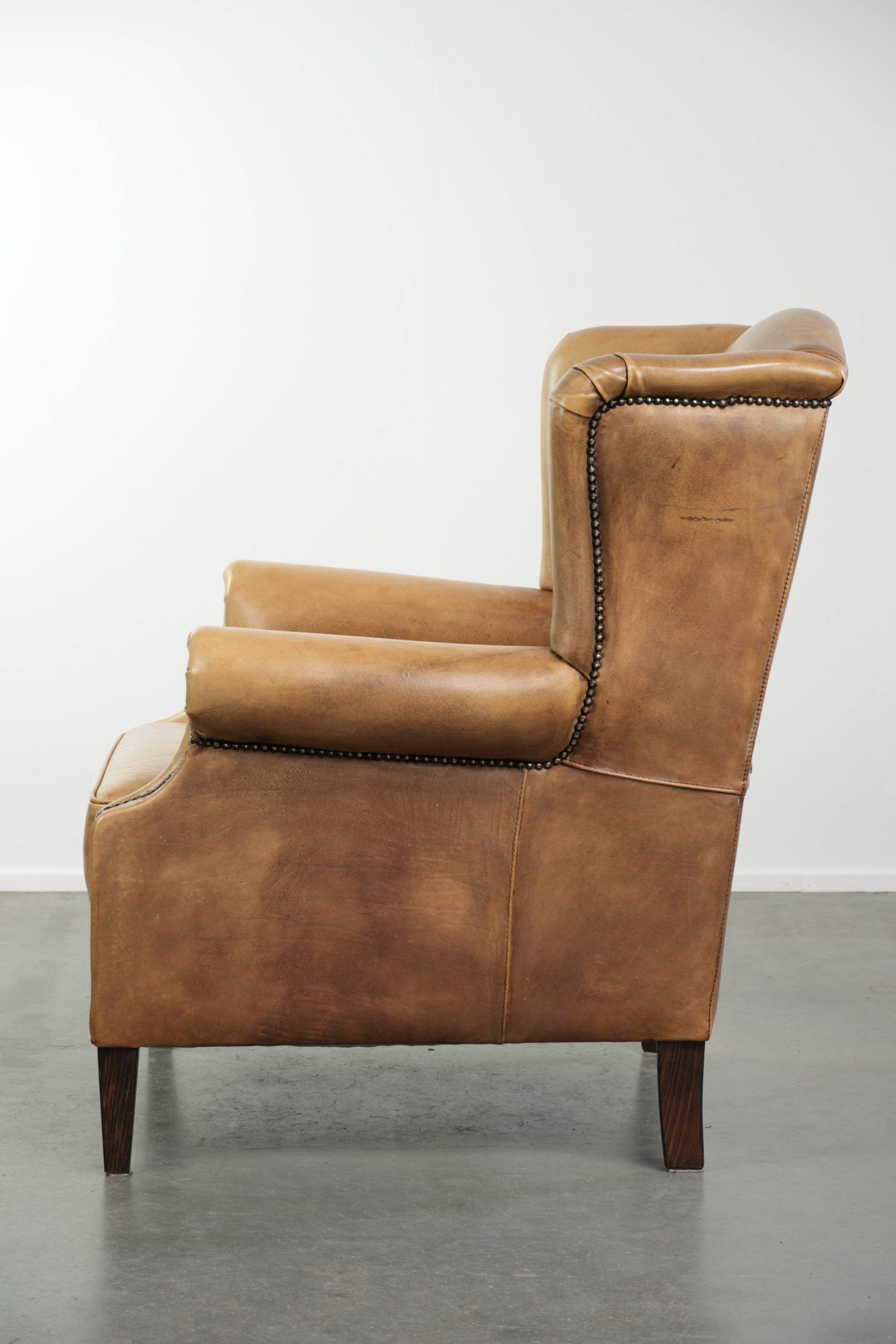 Comfortable cowhide wingback armchair with a timeless English look