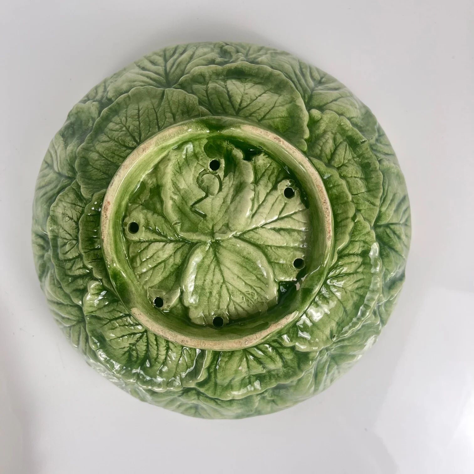 Leaf and strawberry-shaped bowl/strainer.