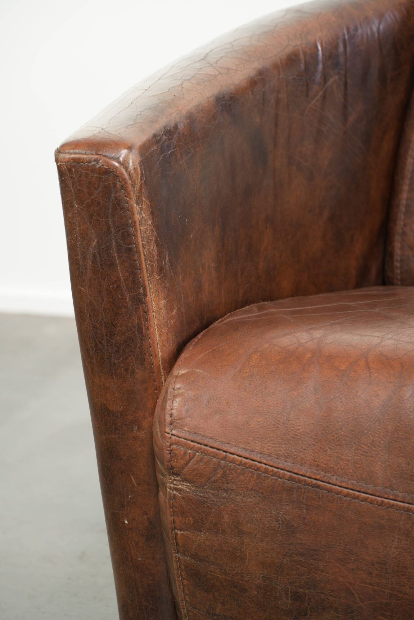 Cowhide armchair in Aviator design in a warm brown colour