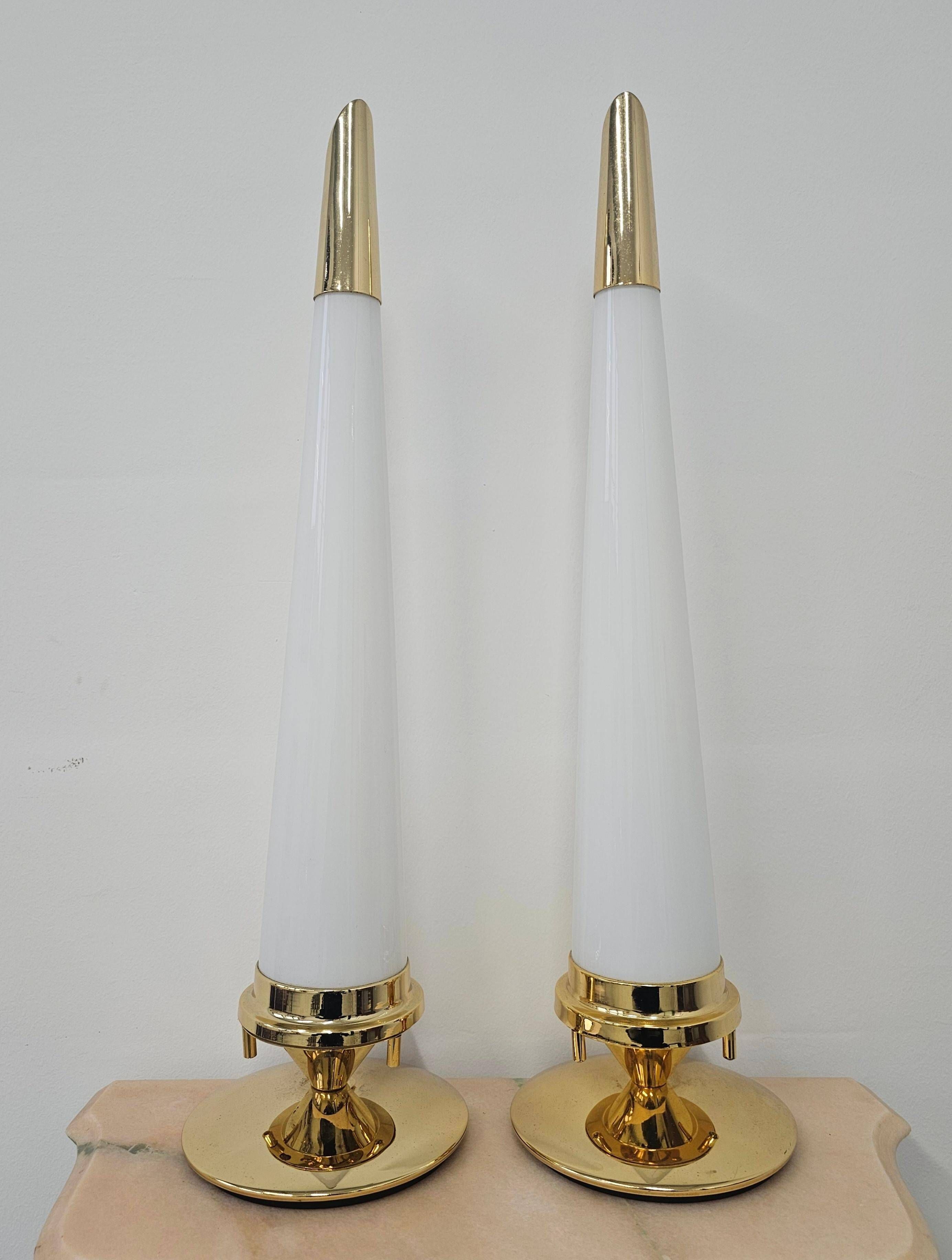 Pair of Hollywood Regency table lamps in brass with glass shades.