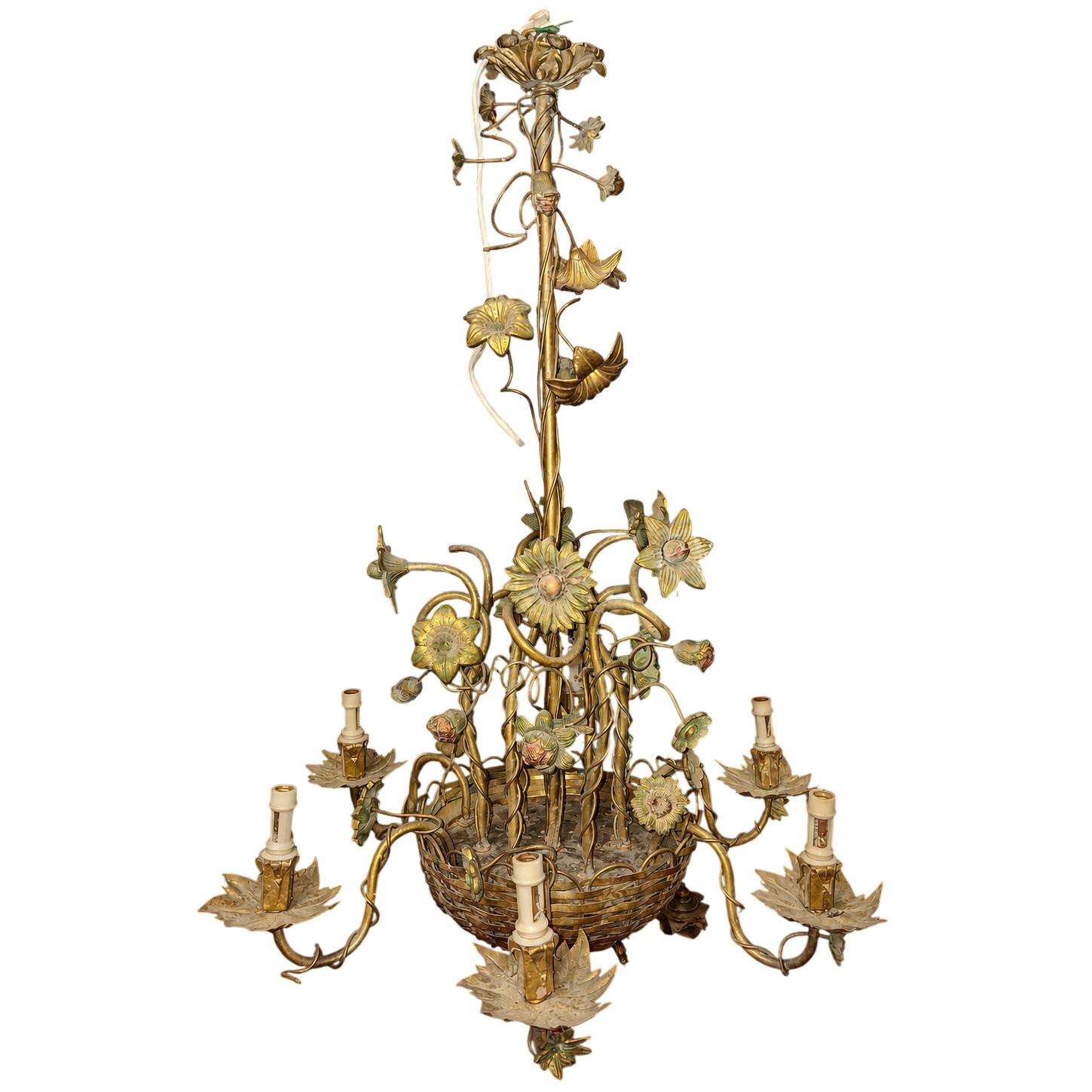 Large floral Art Nouveau chandelier in patinated bronze and metal.