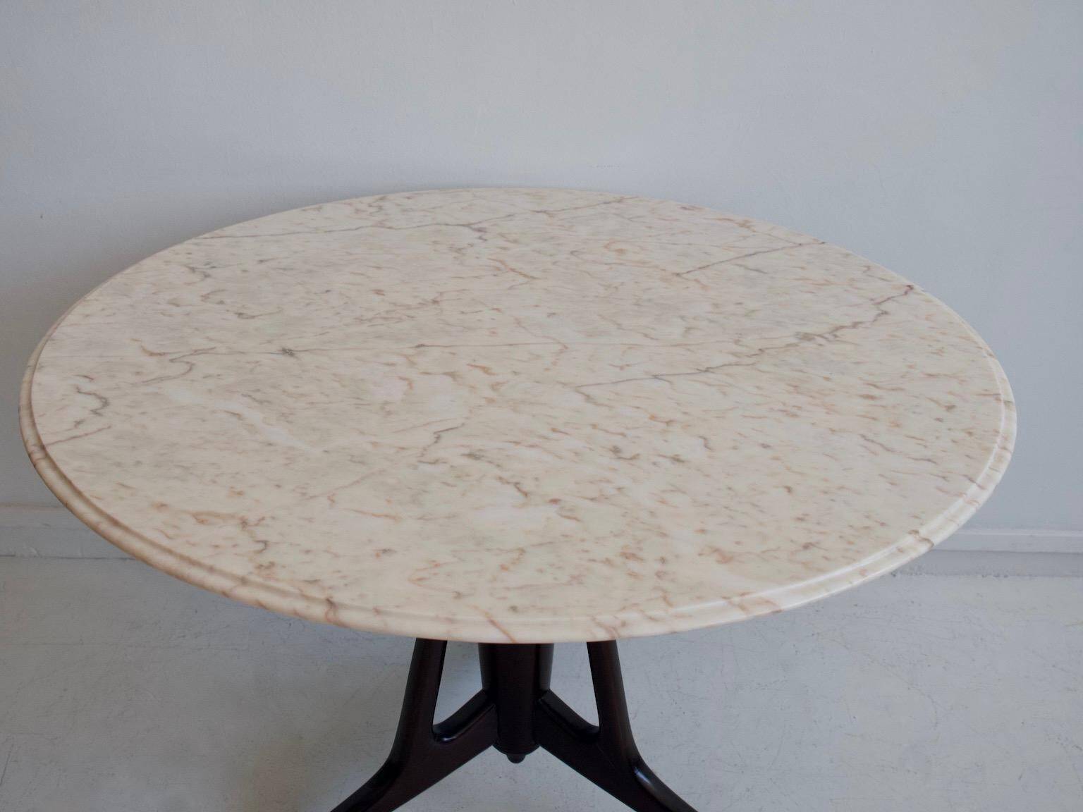 Mid-century modern round dining table in marble and ebony wood.