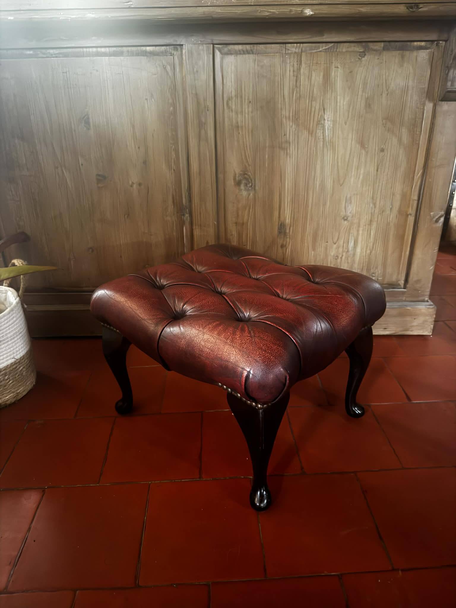 Red leather footrest in Chesterfield style, vintage 1970s.