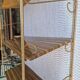 Wall shelf in metal with slanted shelves