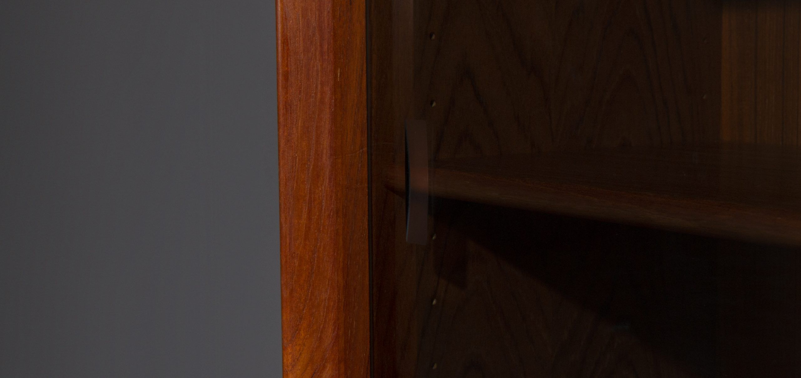 Teak wall cabinet with sliding glass doors