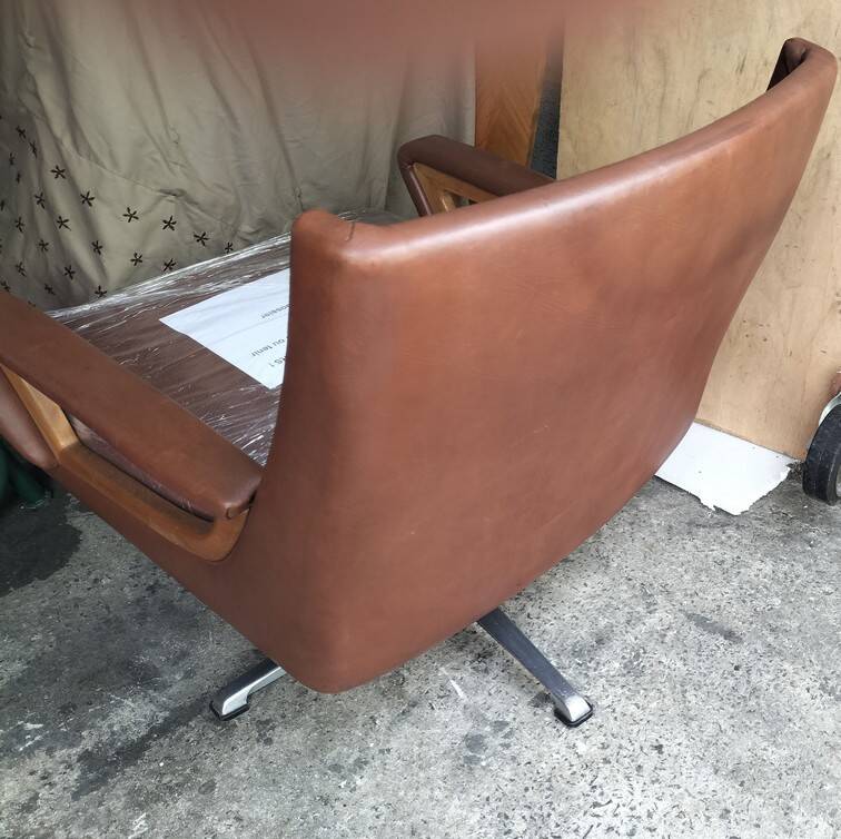 Leather and wood swivel armchair
