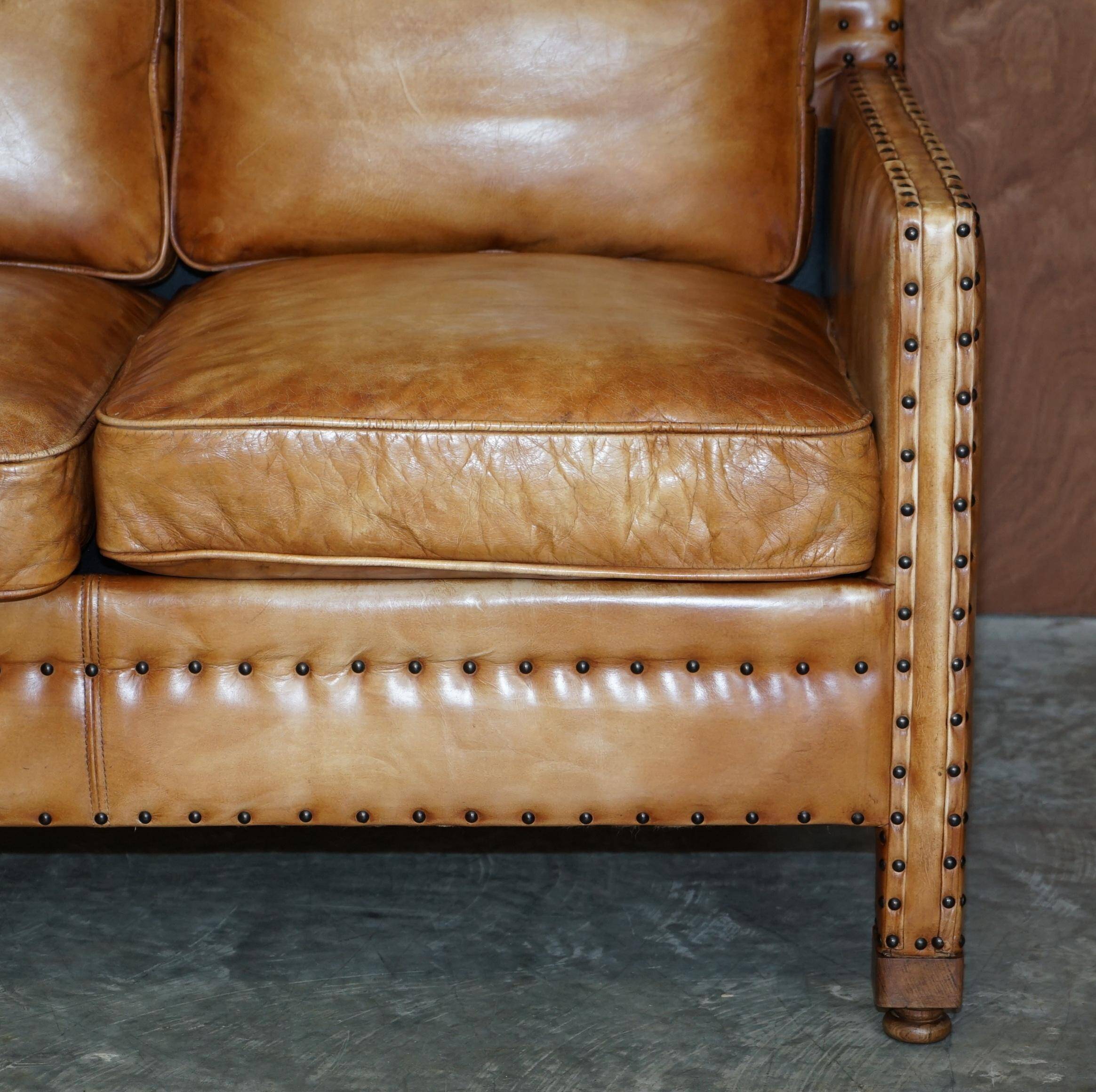 Two-seater leather canapé, hand-tanned, Edwardian style with studs.